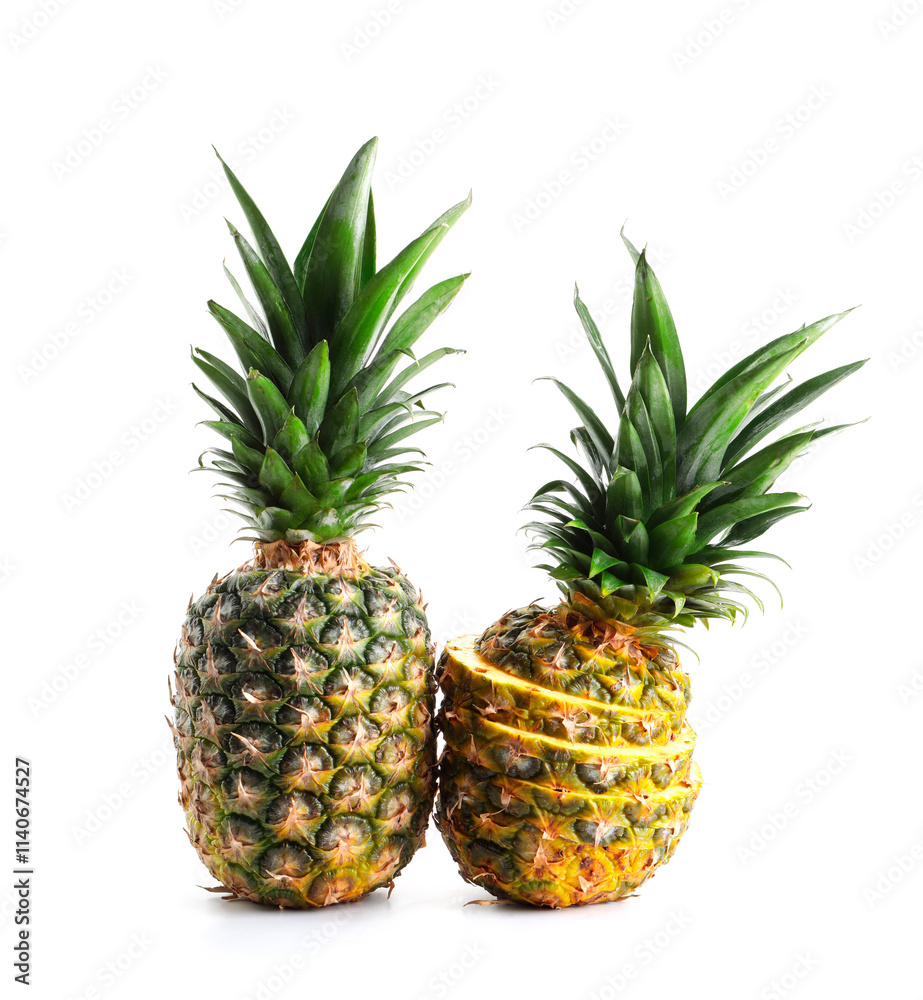 Fototapeta premium Whole and cut ripe pineapples isolated on white
