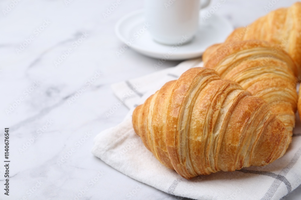 Tasty fresh croissants on white marble table, closeup. Space for text Tasty fresh croissants on white marble table, closeup. Space for text