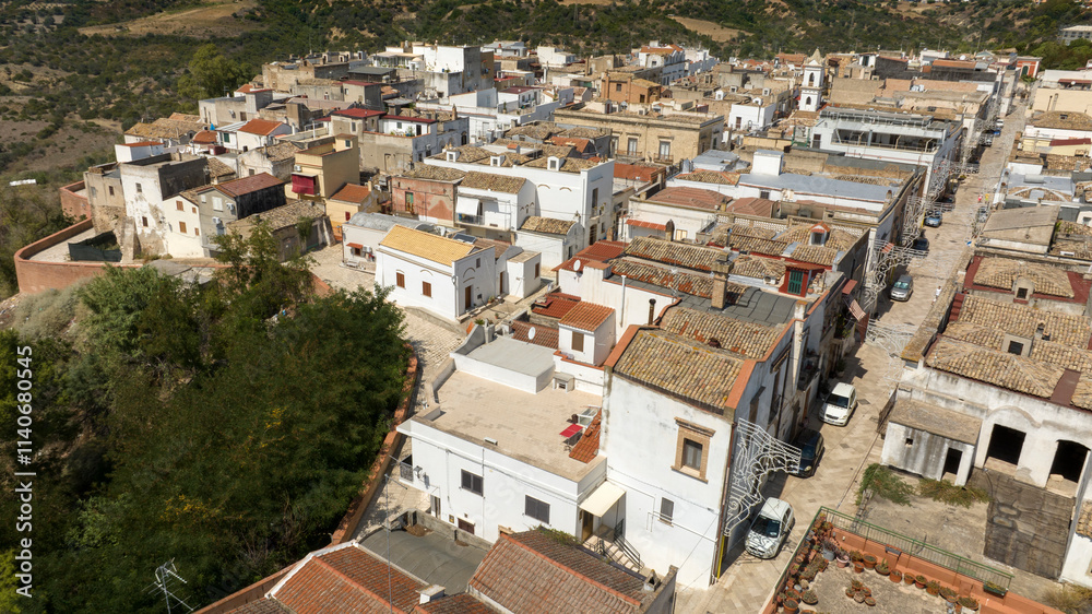 Aerial view of houses, apartments and buildings located in the historic center of the town of Bernalda, in the province of Matera, Basilicata, Italy. It is a traditional Italian village. Aerial view of houses, apartments and buildings located in the historic center of the town of Bernalda, in the province of Matera, Basilicata, Italy. It is a traditional Italian village.