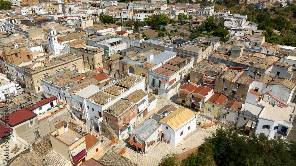 Aerial view of houses, apartments and buildings located in the historic center of the town of Bernalda, in the province of Matera, Basilicata, Italy. It is a traditional Italian village. Aerial view of houses, apartments and buildings located in the historic center of the town of Bernalda, in the province of Matera, Basilicata, Italy. It is a traditional Italian village.