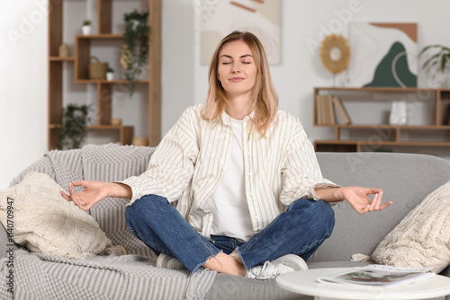 Young woman meditating on s...