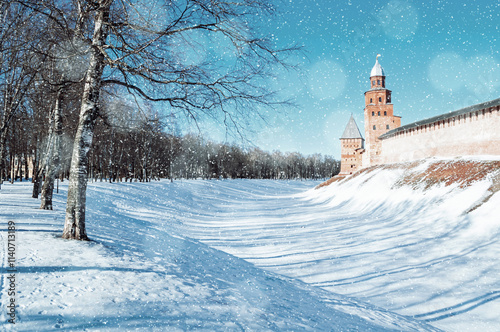 Veliky Novgorod Russia. Veliky Novgorod Kremlin fortress, winter sunny view with falling snowflakes. Focus at the Kremlin. Winter city landscape