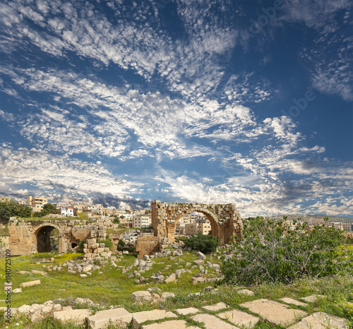 Roman ruins (against the background of a beautiful sky with clouds) in the Jordanian city of Jerash (Gerasa of Antiquity), capital and largest city of Jerash Governorate, Jordan #1140725109