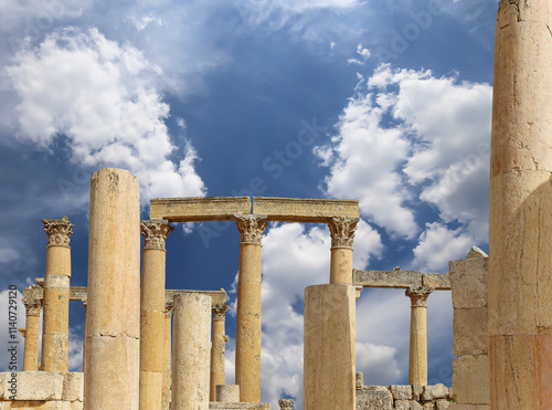 Roman ruins (against the background of a beautiful sky with clouds) in the Jordanian city of Jerash (Gerasa of Antiquity), capital and largest city of Jerash Governorate, Jordan #1140729120