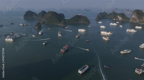 Aerial view of the Hạ Long Bay, Halong Bay is a UNESCO World Heritage Site and popular travel destination in Quảng Ninh province, Vietnam. Cruise ships and islands alternate in the bay. Sunset