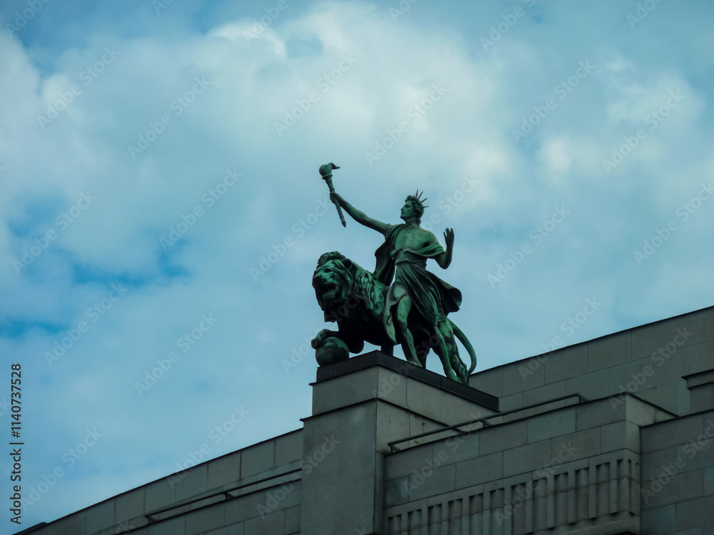 Statue atop the National Museum in Prague is that of Saint Wenceslas, the patron saint of Bohemia. He is depicted riding a horse, holding banner and scepter. Symbol of Czech national identity