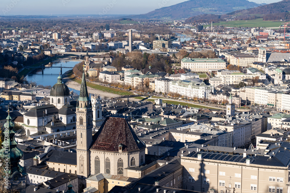 Fototapeta premium Aerial cityscape view of Salzburg Austria, on a sunny winter day, as seen from the fortress Hohensalzburg