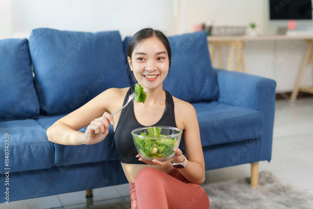 Happy athletic woman enjoying healthy salad after training, promoting wellness and balanced lifestyle