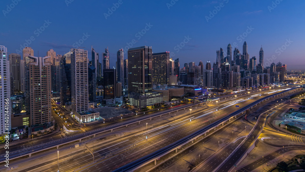 Fototapeta premium Dubai Marina skyscrapers aerial top view before sunrise from JLT in Dubai night to day timelapse, UAE.