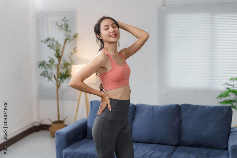 Fit woman in sportswear enjoying a moment of relaxation after her workout, promoting health and wellness at home Fit woman in sportswear enjoying a moment of relaxation after her workout, promoting health and wellness at home