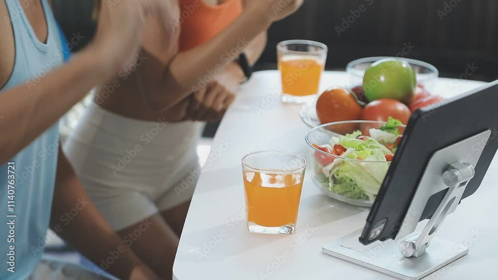 Nutritionist is giving online dietary advice to a client, with fresh vegetables and a salad on the table in front of her Nutritionist is giving online dietary advice to a client, with fresh vegetables and a salad on the table in front of her