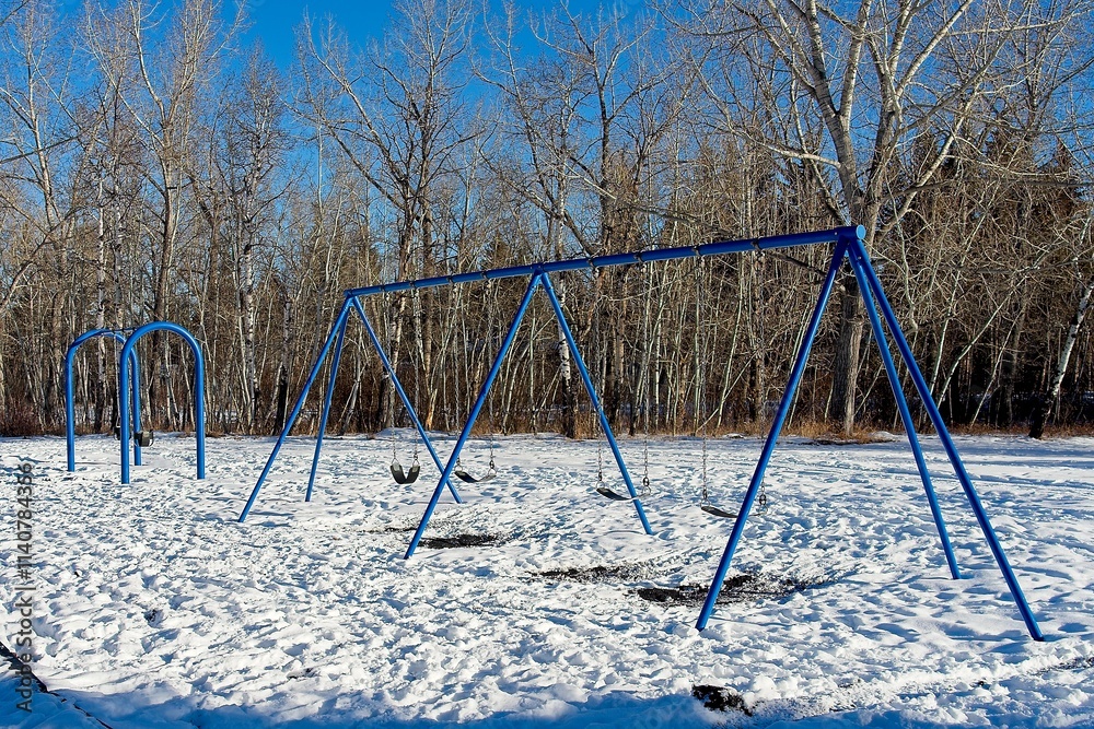 Swings in winter playground with snow Swings in winter playground with snow