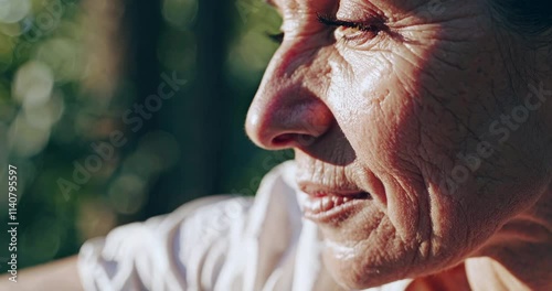 Close-Up Portrait of Elderly Woman with Wrinkled Skin in Sunlight Reflecting Grace and Life Experience photo