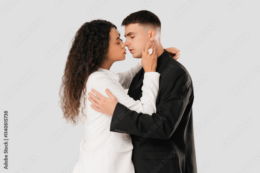 Young couple kissing on white background. Yin Yang concept Young couple kissing on white background. Yin Yang concept