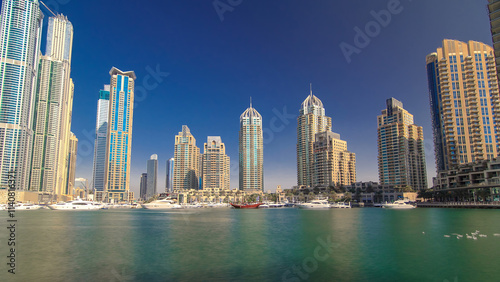 Dubai Marina with tallest skyscrapers and boats timelapse hyperlapse photo