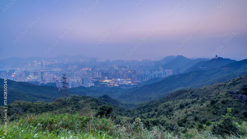 Fototapeta premium Cityscape of Hong Kong as viewed atop Kowloon Peak with day to night timelapse with Kowloon below
