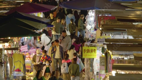 People walking at night market, Asia, Hong Kong, Mong Kok (with tilt)