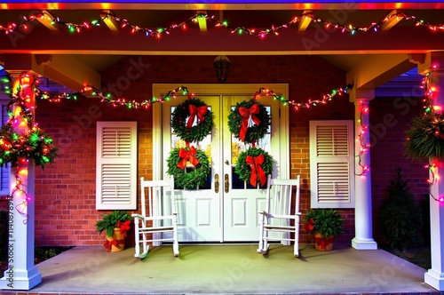 Festively Decorated Front Porch with Christmas Wreaths and Colorful Lights photo