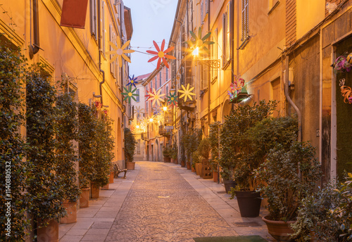 Fototapeta Naklejka Na Ścianę i Meble -  ALESSANDRIA, ITALY - SEPTEMBER 10, 2024: The street Via Milano in the morning dusk.