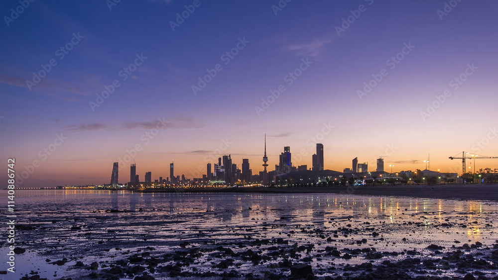 Fototapeta premium Seaside skyline of Kuwait city from night to day timelapse