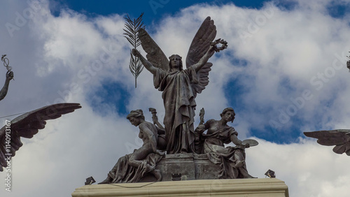 Statue on the top of government palace facade the Ministry of Agriculture building timelapse hyperlapse in Madrid, Spain. photo