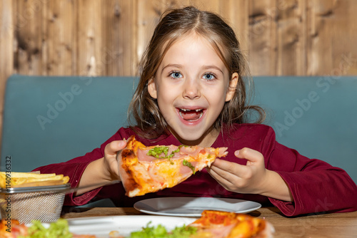 Funny little girl eating italian pizza for lunch close up. Charming happy child girl laugh and biting off big slice of fresh made pizza. Fast street food and children concept. High quality photo photo