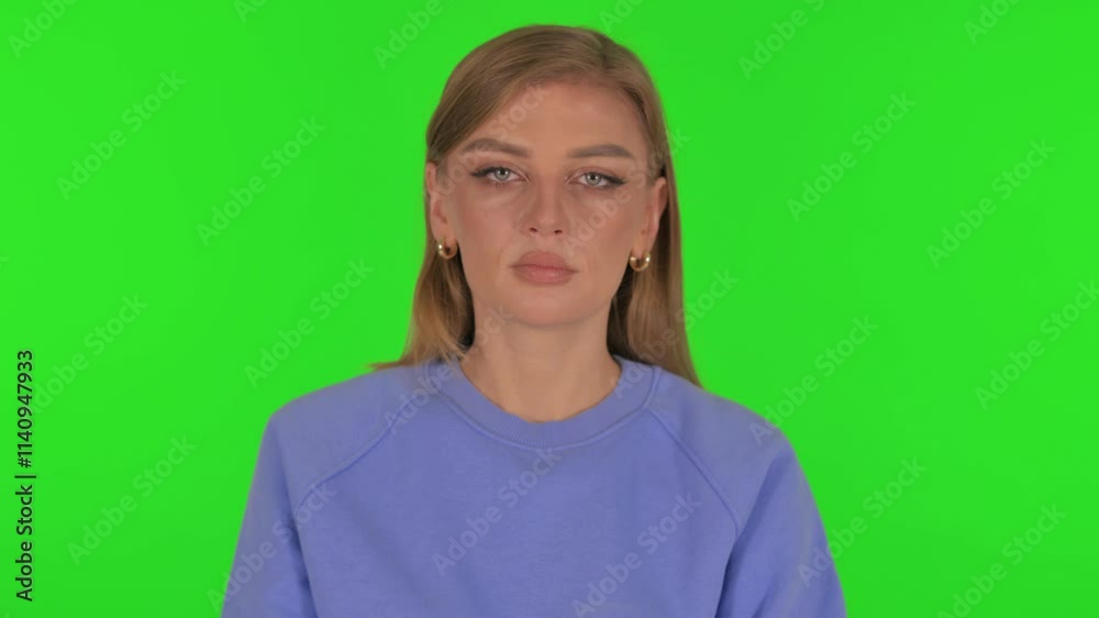 Tense Woman in Denial on Green Background Tense Woman in Denial on Green Background