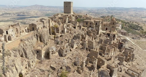 Aerial view of the church located in Craco, a ghost town in the province of Matera, Basilicata, Italy. The historic center was depopulated due to a landslide and has become a tourist destination.