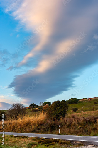 Golden clouds at sunset over the mountain road of the Sierra de Guadarrama, Madrid.