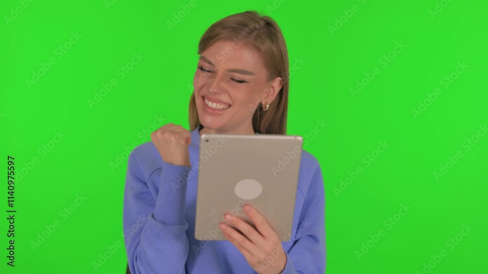 Woman Celebrating Success on Tablet on Green Background Woman Celebrating Success on Tablet on Green Background
