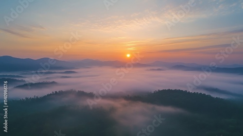 Majestic sunrise over misty mountain landscape with lush forests and serene atmosphere