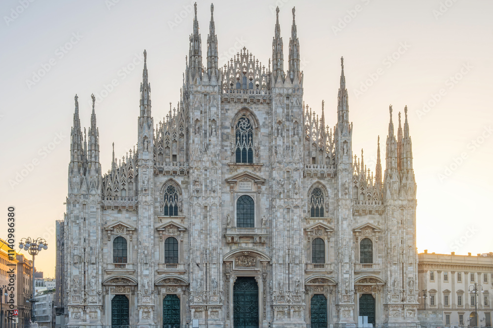 Milan Cathedral on Cathedral square in the morning, Milan, Lombardia, Italy. Piazza del Duomo with Duomo di Milano with intricate Gothic architecture Milan Cathedral on Cathedral square in the morning, Milan, Lombardia, Italy. Piazza del Duomo with Duomo di Milano with intricate Gothic architecture