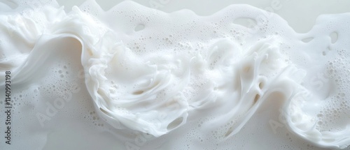 Close-up of a white liquid, which appears to be soap or lotion. the liquid has a smooth texture and is flowing in a wave-like manner.