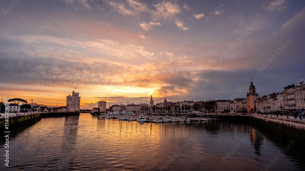 The coastal town of La Rochelle in France with its two medieval towers at sunset.