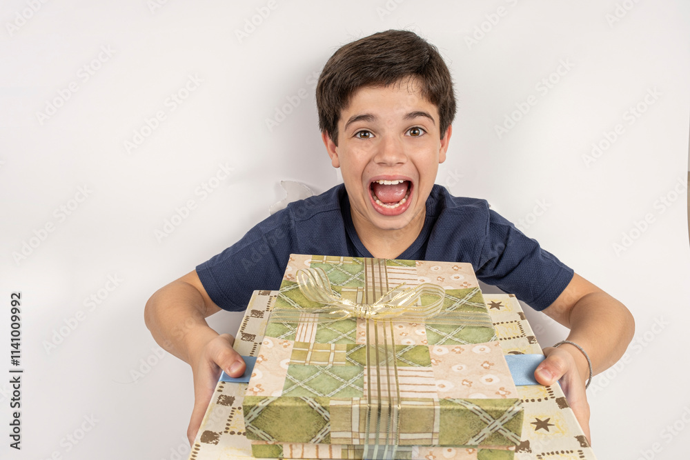 Happy 11 year old Brazilian child with body through a cardboard with two gifts. Happy 11 year old Brazilian child with body through a cardboard with two gifts.