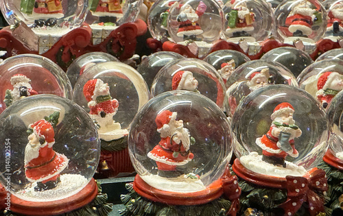 Festive santa claus snow globes collection with christmas decorations photo