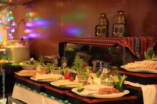 Buffet arranged with variety of beautifully arranged dishes, complemented by vibrant decor and twinkling lights, creating a festive atmosphere for any celebration