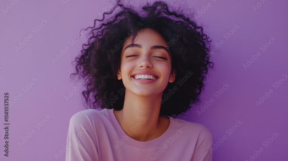 Young woman smiling in front of a purple wall Young woman smiling in front of a purple wall