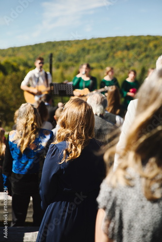 People gathered together singing at a wedding ceremony in Ontario, Canada. photo