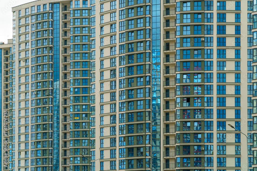 Modern skyscrapers in the new area. Tall buildings made of glass against the sky. Buying or renting luxury real estate. Modern skyscrapers in the new area. Tall buildings made of glass against the sky. Buying or renting luxury real estate.