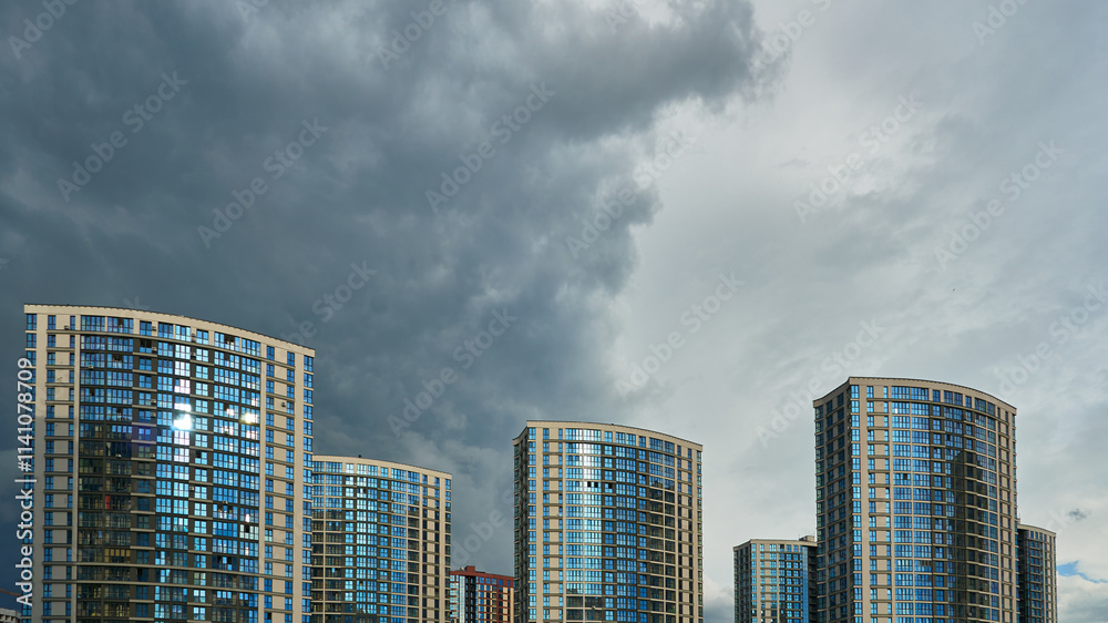 Modern skyscrapers in the new area. Tall buildings made of glass against the sky. Buying or renting luxury real estate. Modern skyscrapers in the new area. Tall buildings made of glass against the sky. Buying or renting luxury real estate.