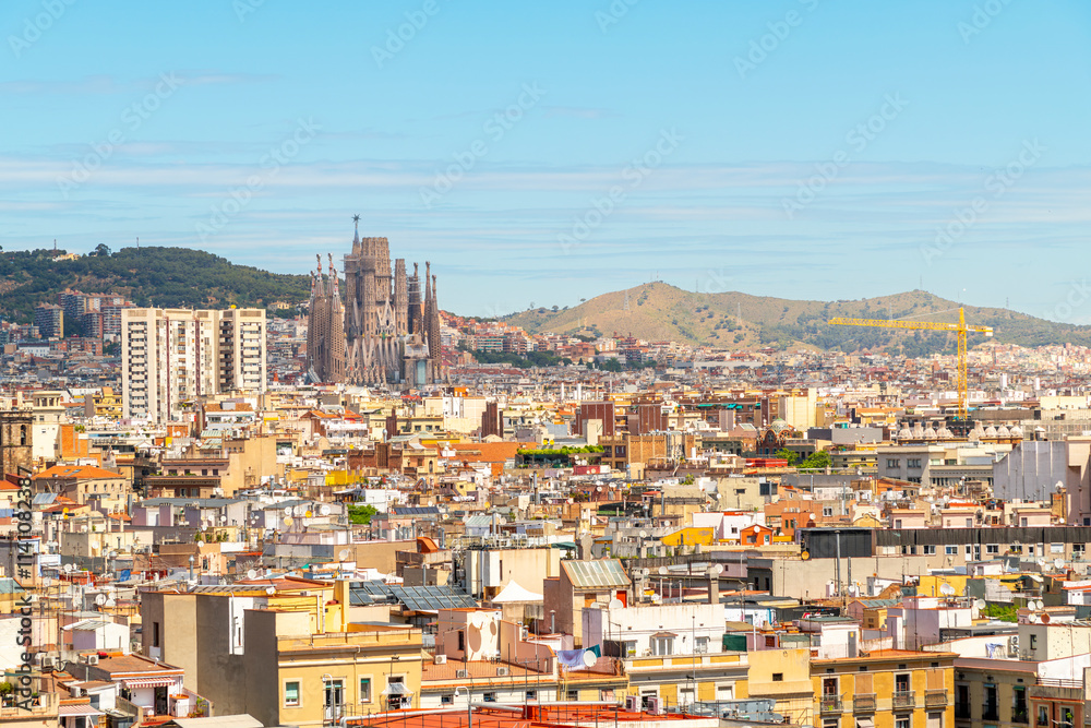 The Sagrada Familia Basilica seen from the rooftop of the Barcelona Cathedral on a summer day in the historic center of Barcelona, Spain. The Sagrada Familia Basilica seen from the rooftop of the Barcelona Cathedral on a summer day in the historic center of Barcelona, Spain.