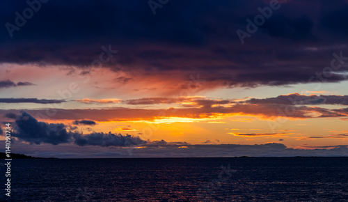 Sunrise Over Calm Waters Under Vibrant Skies on the West Coast