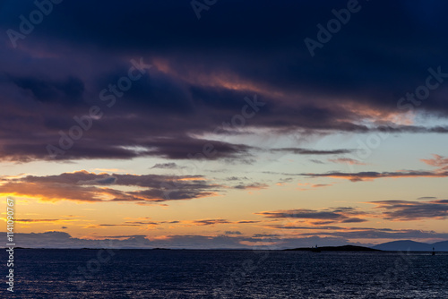 Tranquil Ocean Landscape with Sunset Over Calm Waters and Distant Islands