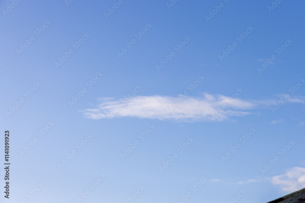 Peaceful Blue Sky with a Feather-Like Cloud Formation Peaceful Blue Sky with a Feather-Like Cloud Formation