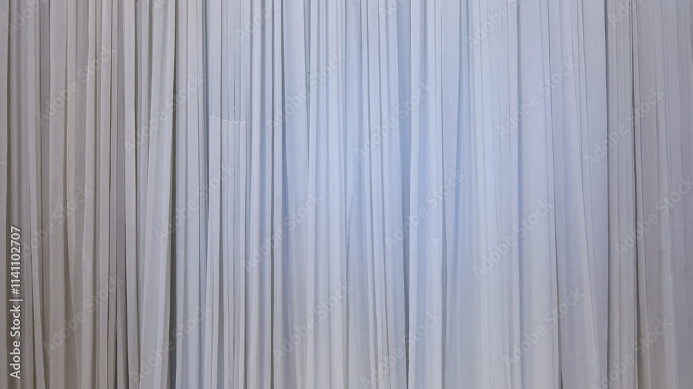 White grey curtain background. Abstract of curtain wall with light grey vertical stripes with copy space. Selective focus White grey curtain background. Abstract of curtain wall with light grey vertical stripes with copy space. Selective focus