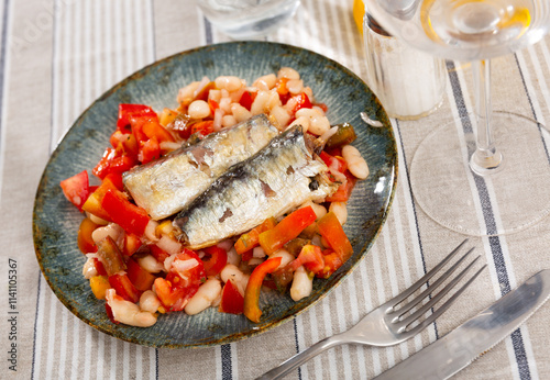 Delicious fresh salad with sardines, beans and pim tom served on plate photo