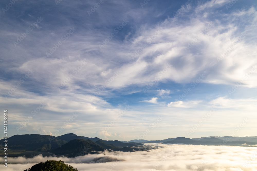 Obraz premium Amazing Sunrise or sunset over mountains hills covered with mist, Aerial view landscape drone shot beautiful colorful nature background