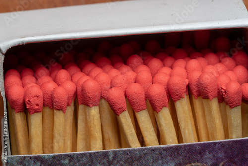 Several red-headed phosphor sticks arranged inside the box photo