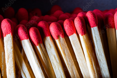 Several red-headed phosphor sticks arranged inside the box